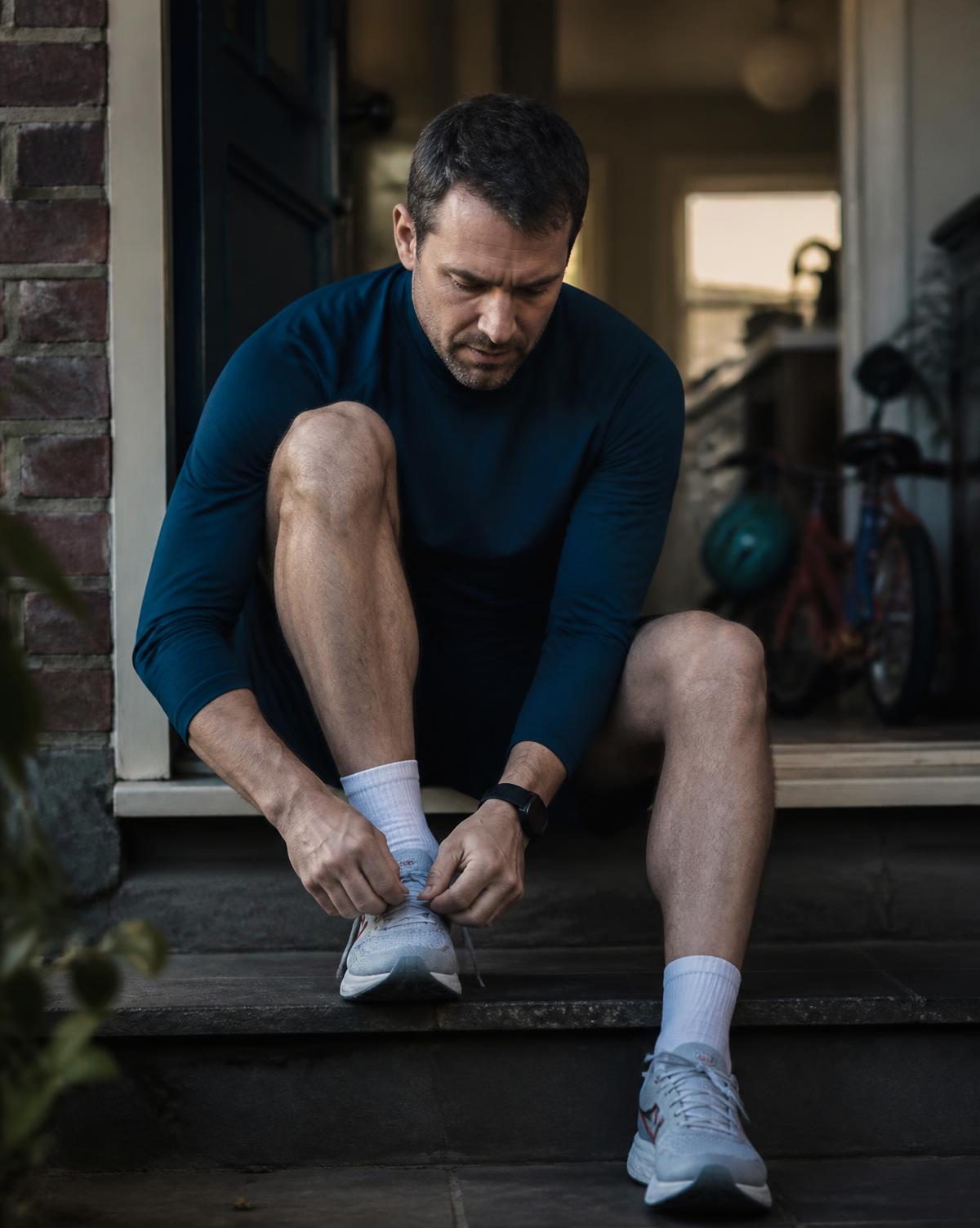 Chris lacing his running shoes on the doorstep early in the morning